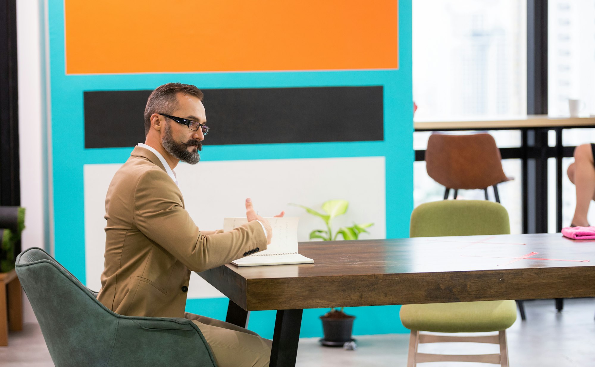 Caucasian businessman working at desk in co working space.